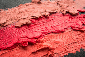 Fototapeta premium Multicolored lipstick, on a black background