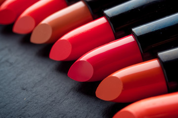 Multicolored lipstick, on a black background