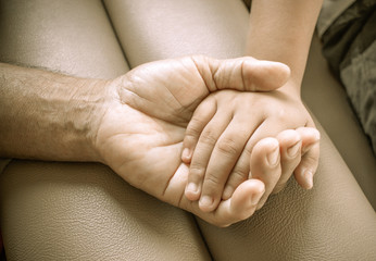 Hands of elderly man holding, touches asian kids, World Kindness Day concept and Adult day care, soft tone