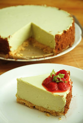 Green tea cheesecake with strawberry on white dish