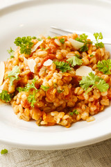 Pearl barley and tomato stew on white platter