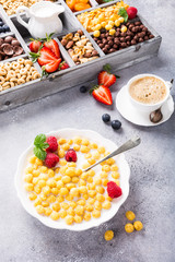 Healthy breakfast with cereal balls, fresh milk and berries, selective focus.