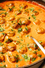 Herring balls in tomato and coconut milk sauce