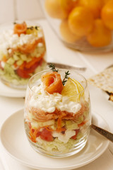 Glass of dessert with fresh salmon, cream and lime