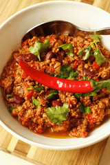 Chilli with minced  beef and herbs on white bowl