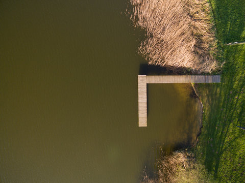 Aerial View Of A Smal Wooden Dock On A Lake - Top View