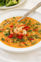 Hearty tomato soup with prawns on white platter