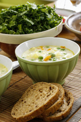 Seasonal vegetable soup with cheese spread on table