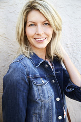 Portrait of blond woman in denim, smiling