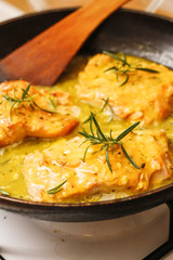Baked salmon orange and rosemary sauce in black pan