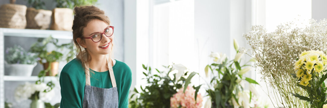 Young florist smiling
