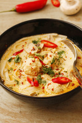Spicy fish ball soup with coconut milk and chili