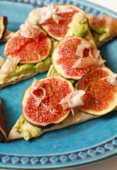 Fototapeta na wymiar Pizza with fresh figs, avocados and maple syrup on platter