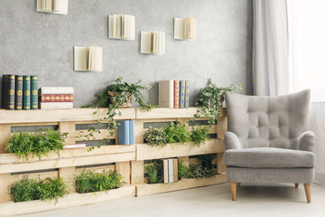 Books and plants on shelf © Photographee.eu
