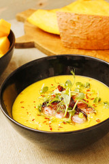 Pumpkin and lentil soup with crispy bacon