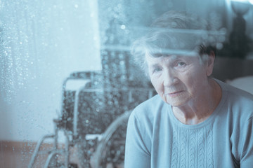 Sad, senior disabled woman