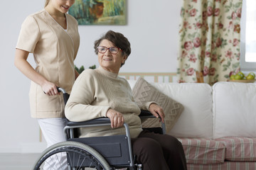 Woman on wheelchair and her nurse