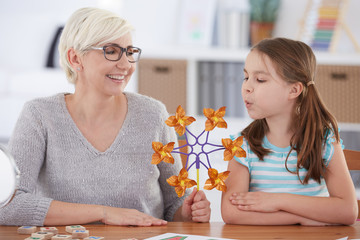 Girl interested in paper windmill