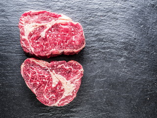 Rib eye steaks on the black background.