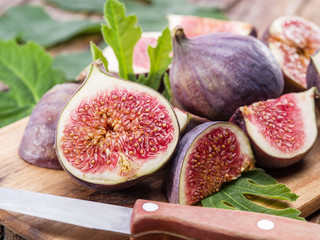 Ripe fig fruits on the wooden table.