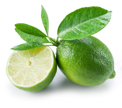Ripe lime fruit with a half on the white background.