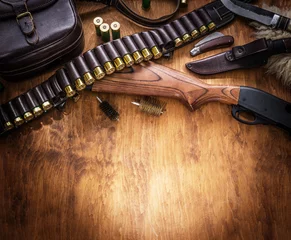 Poster Pump action shotgun, 12 guage cartridge and hunting knife. © volff