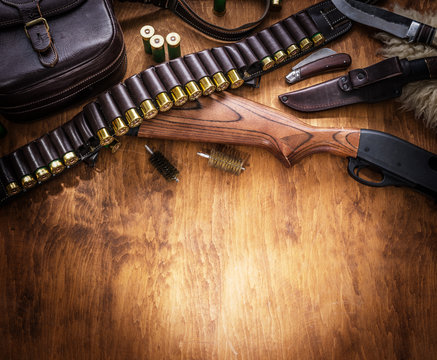 Pump action shotgun, 12 guage cartridge and hunting knife.