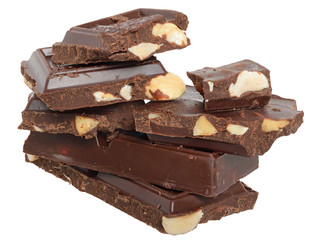 Heap cubes of chocolate with nuts close up isolated