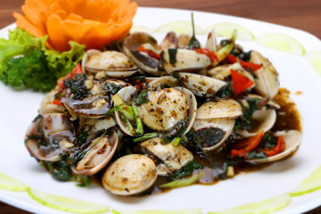 Sauteed clams with soyal sauce and onion on white platter