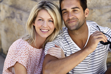 Fototapeta premium Smiling couple sitting in city