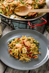 Traditional seafood paella with shrimp, fish and chicken seved i