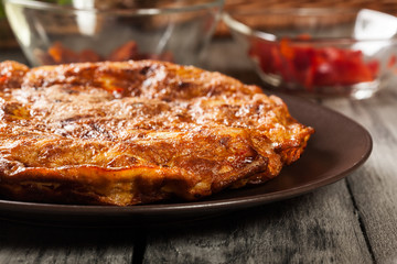 Tortilla de patatas. Spanish omelette with sausage chorizo, potatoes, paprika and egg, accompanied by olive oil