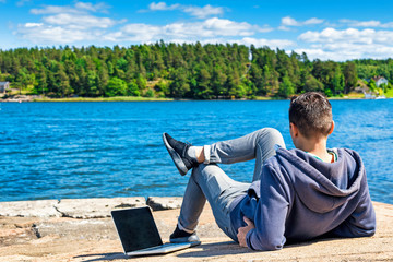 Fototapeta na wymiar Businessman working on the beach with a laptop