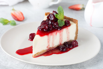 Cheesecake - Food & Drink
 Like
 Save
Slice of plain cheesecake with cranberry sauce on white plate decorated with mint leaf. Closeup view
