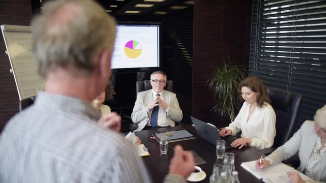 Business team listening attentively coworkers speech 
