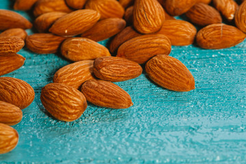handful of almonds on a blue wooden background