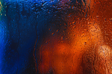 Drops of rain on the window of the car in the evening