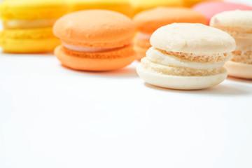 Colorful macaroon on white background, the sweet course eaten at the end of a meal..