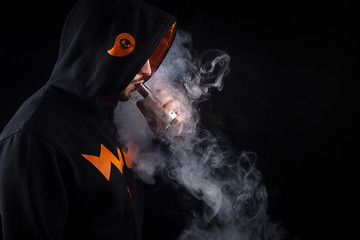 vaping man holding a mod. A cloud of vapor.
