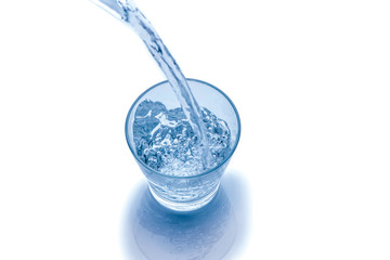Drinking water is poured into a glass