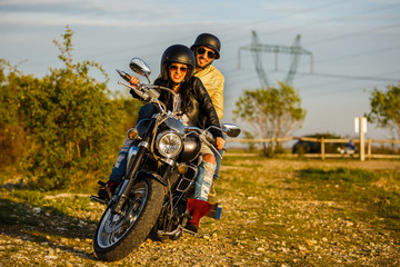 Fototapeta na wymiar Beautiful young couple with a classic motorcycle