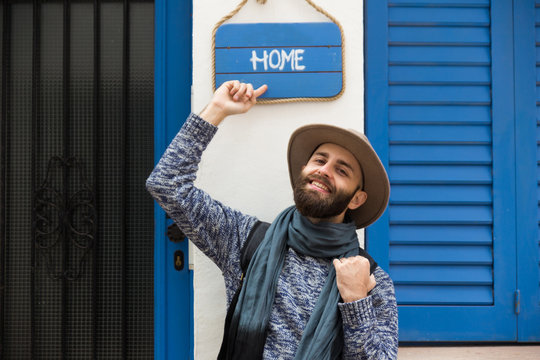Cheerful man pointing on sign