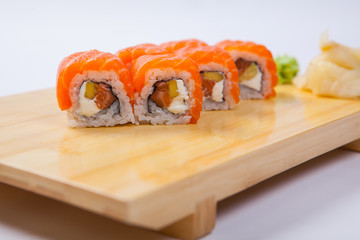 Sushi with salmon on a wooden tray