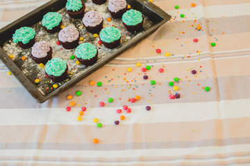 colorful cupcakes are on the tray