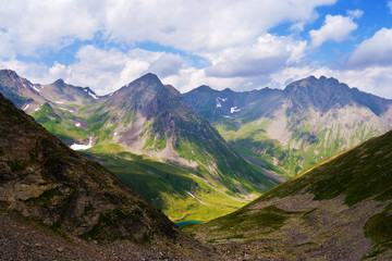 Naklejka premium A beautiful view of the mountains of the Caucasus. The clouds in the blue sky.
