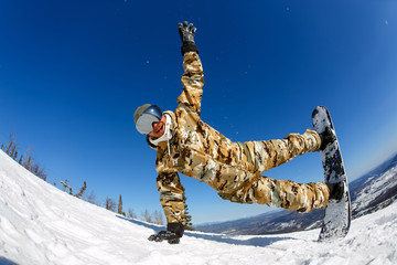 A guy snowboarder enjoys a holiday at the ski resort