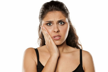 Naklejka premium The young brunette has a toothache