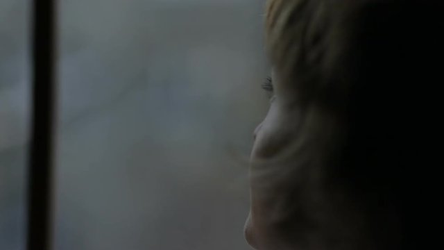 Close up of woman sad near window thinking about something, broken-hearted