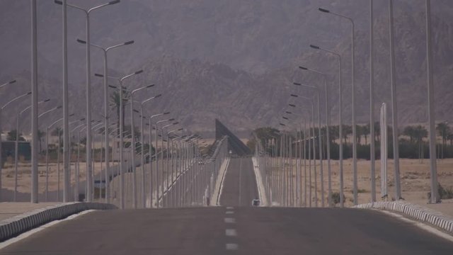 Lonely road near the desert mountains