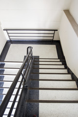 Photograph of stairway in high building.